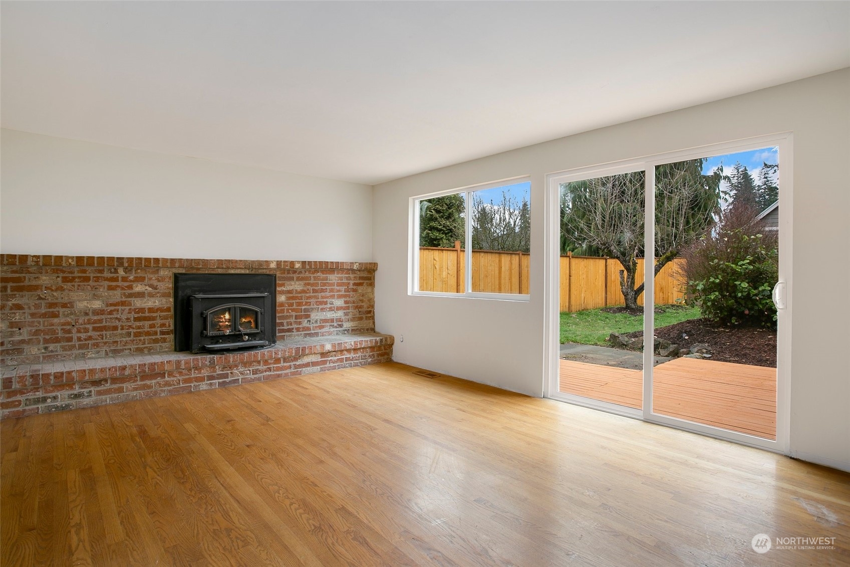 16810 143rd Avenue Southeast Renton, WA 98058 - Photo 10 of 38 an empty room with furniture and a fireplace