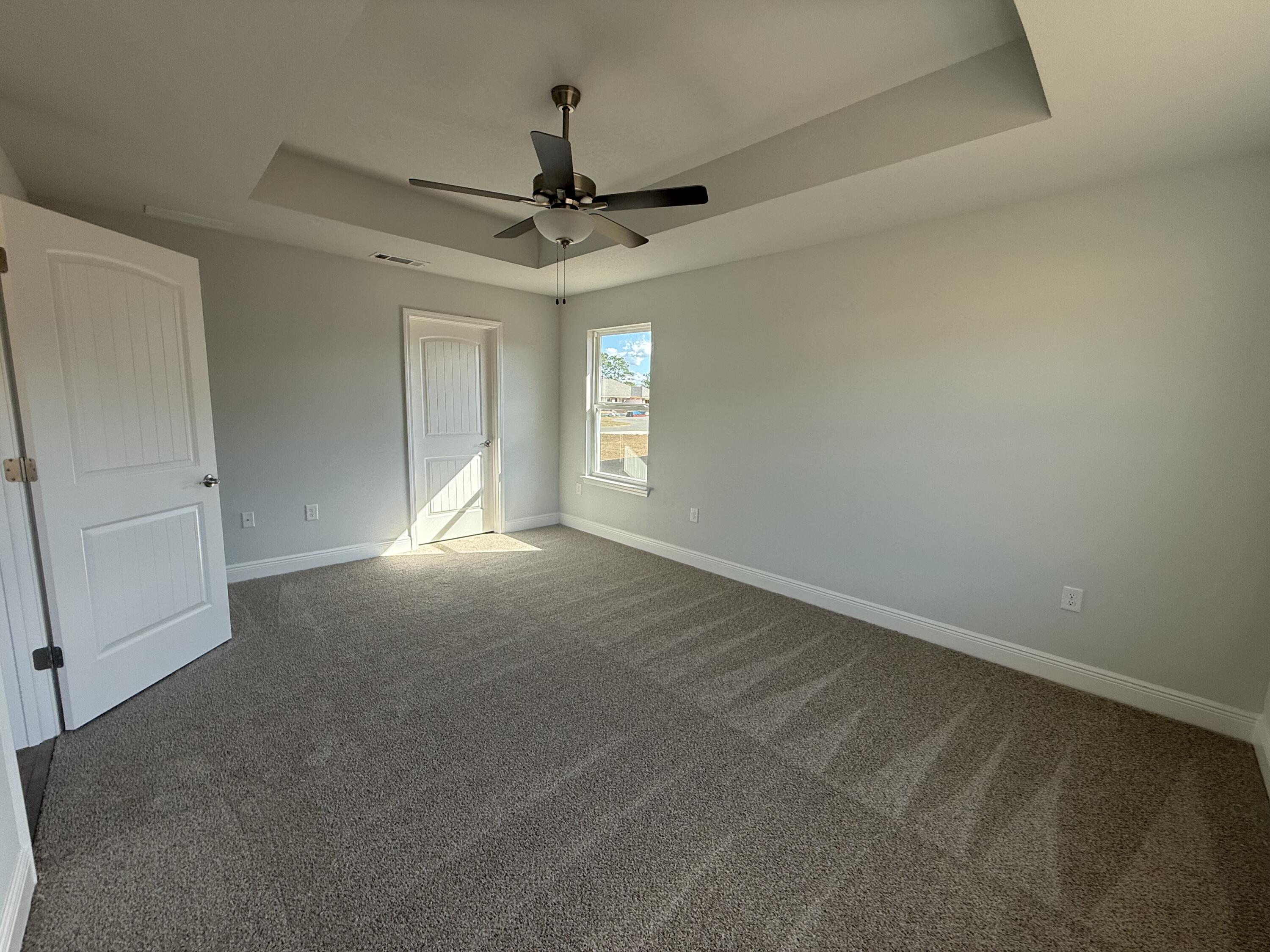 6011 Crocket Cove Crestview, FL 32539 - Photo 15 of 18 en empty room with windows and ceiling fan