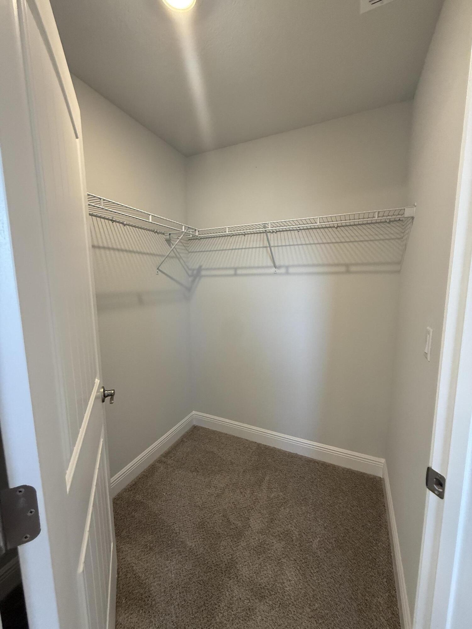 6011 Crocket Cove Crestview, FL 32539 - Photo 16 of 18 a view of a room with racks on the wall