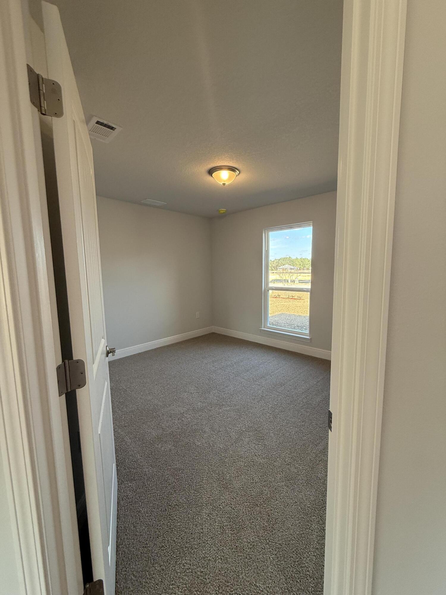6011 Crocket Cove Crestview, FL 32539 - Photo 5 of 18 a view of an empty room and a window