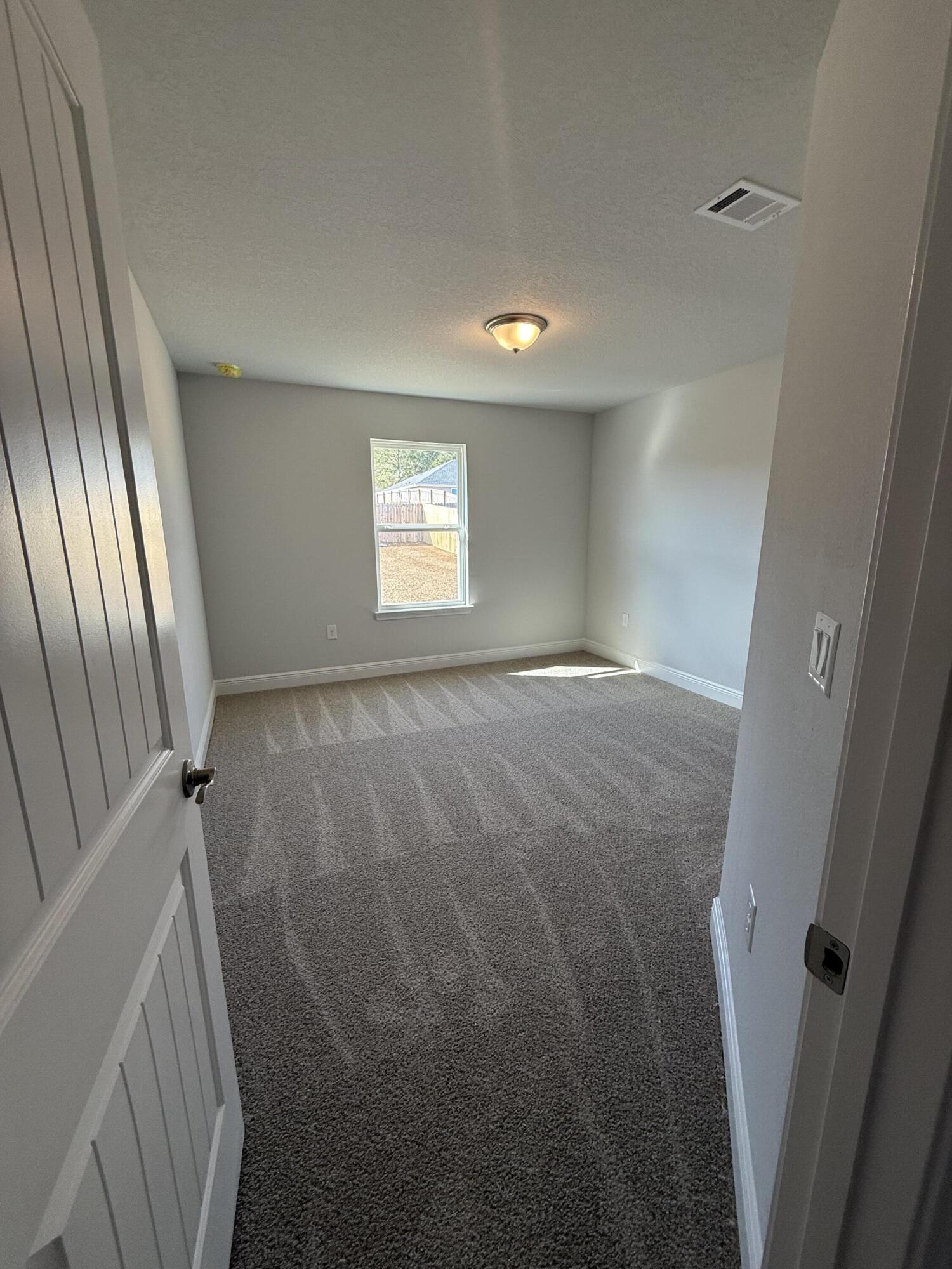 6011 Crocket Cove Crestview, FL 32539 - Photo 6 of 18 a view of empty room with window and stairs