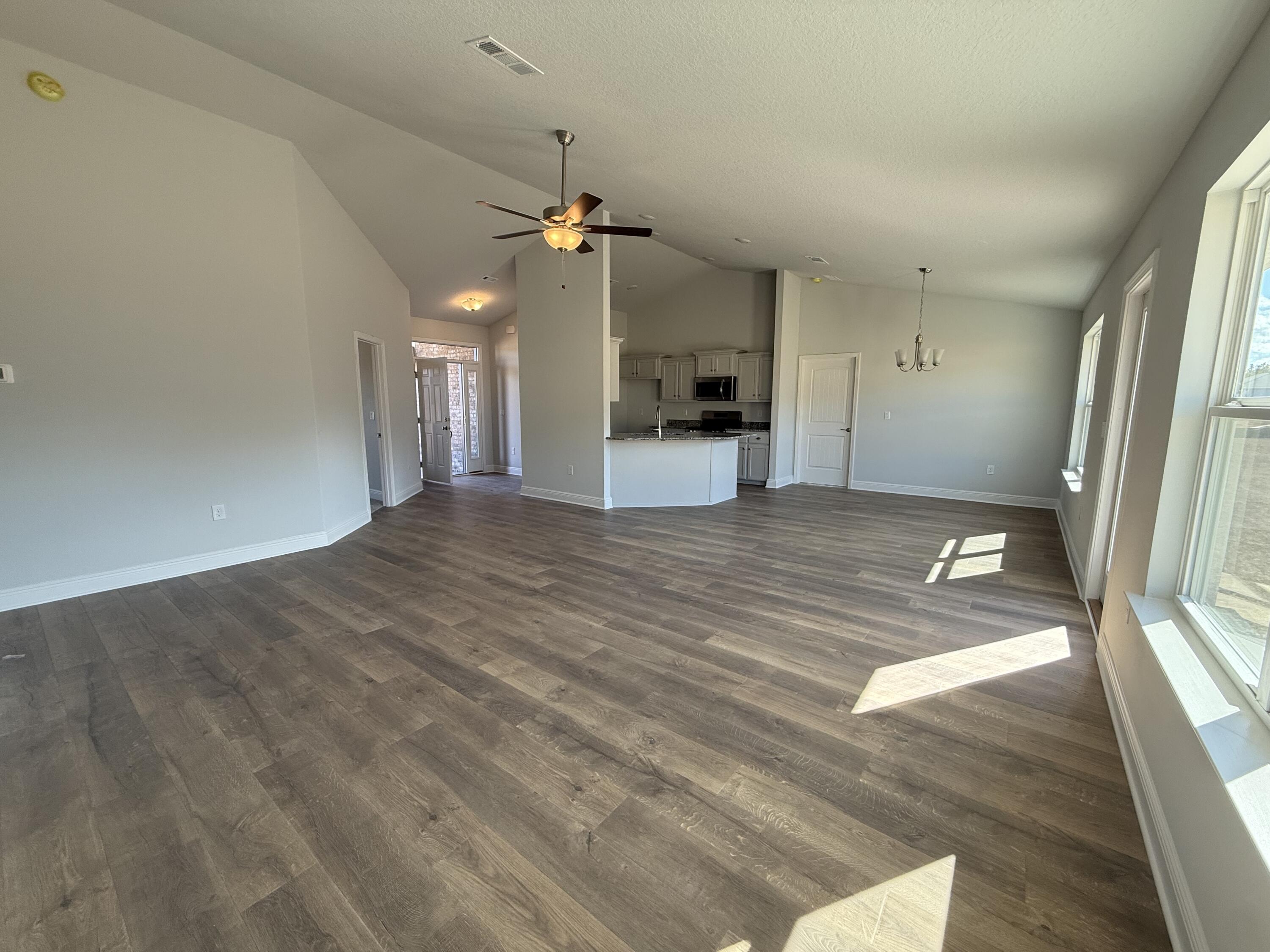 6011 Crocket Cove Crestview, FL 32539 - Photo 10 of 18 a view of a kitchen with a sink hardwood floor and a ceiling fan