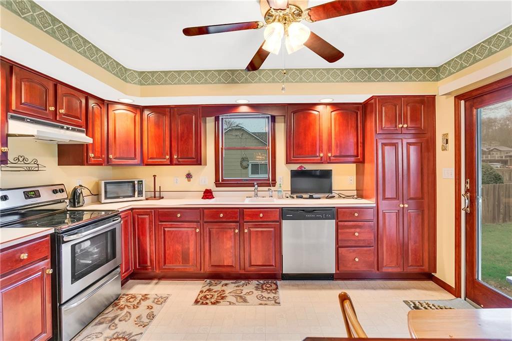 310 Roberts Road Pittsburgh, PA 15239 - Photo 3 of 25 a kitchen with stainless steel appliances granite countertop a stove sink and cabinets