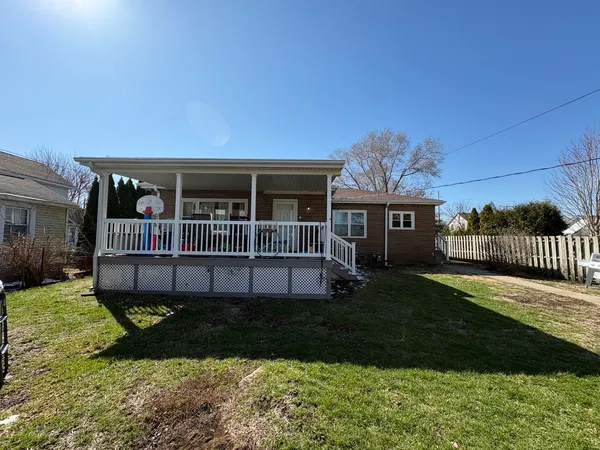 a view of house with a yard