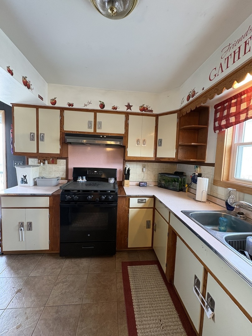 913 Canal Street Ottawa, IL 61350 - Photo 11 of 30 a kitchen with stainless steel appliances granite countertop a stove and a sink