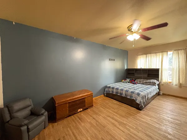a bedroom with bed and window
