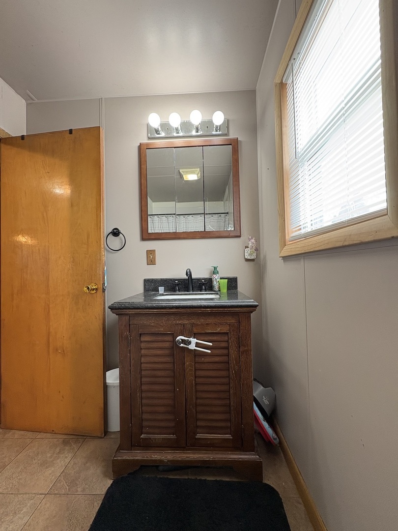 913 Canal Street Ottawa, IL 61350 - Photo 24 of 30 a bathroom with a sink a mirror and a window