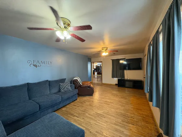 a living room with furniture and a chandelier