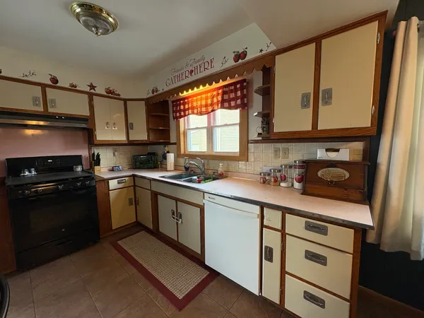 a kitchen with a sink stove and microwave