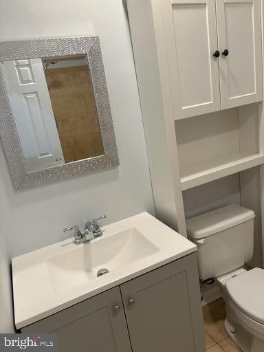 6803 Wild Rose Court Springfield, VA 22152 - Photo 16 of 49 a bathroom with a sink a toilet and a mirror
