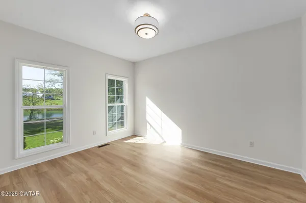 a view of a dry yard with trees