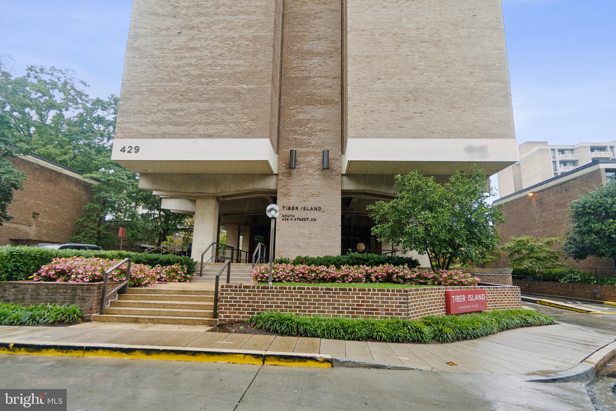 429 N Street Southwest, Unit S401 Washington, DC 20024 - Photo 22 of 23 a front view of a house with a garden and plants