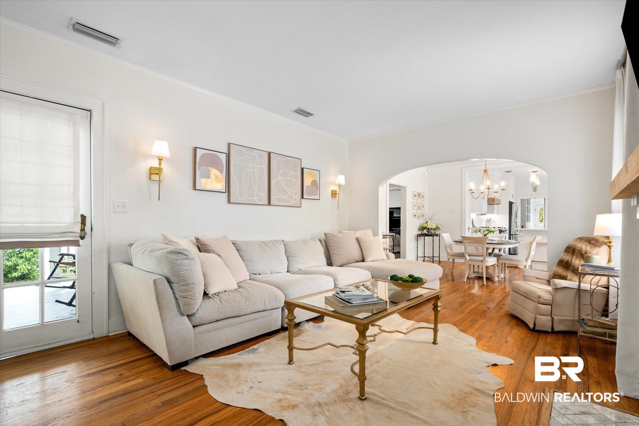112 Crenshaw Street Mobile, AL 36606 - Photo 4 of 21 Living area with visible vents, light wood-type flooring, arched walkways, and a chandelier