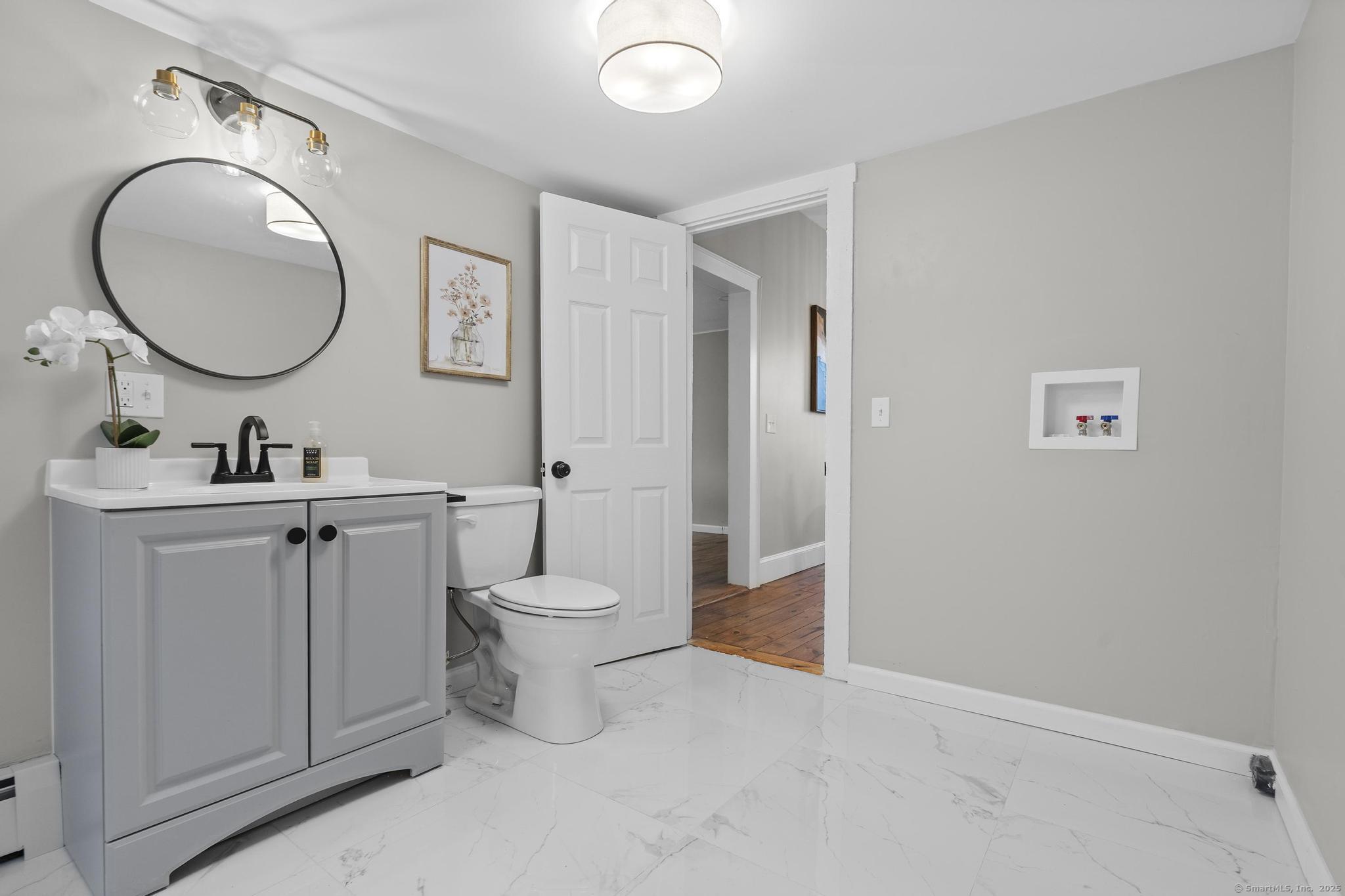 72 Spencer Street Suffield, CT 06078 - Photo 13 of 39 a bathroom with a toilet a sink and a mirror