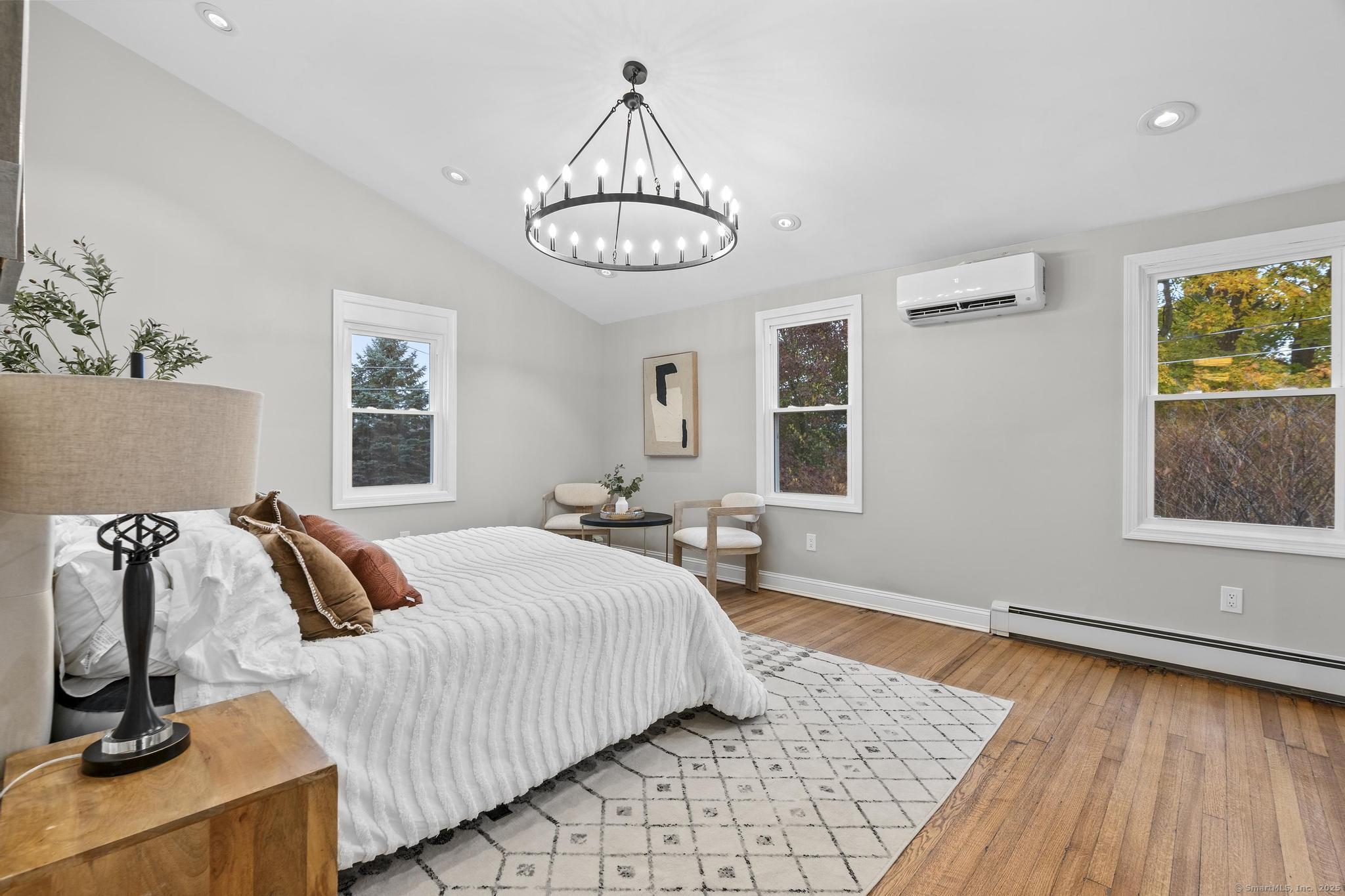 72 Spencer Street Suffield, CT 06078 - Photo 13 of 39 a bedroom with a bed and wooden floor