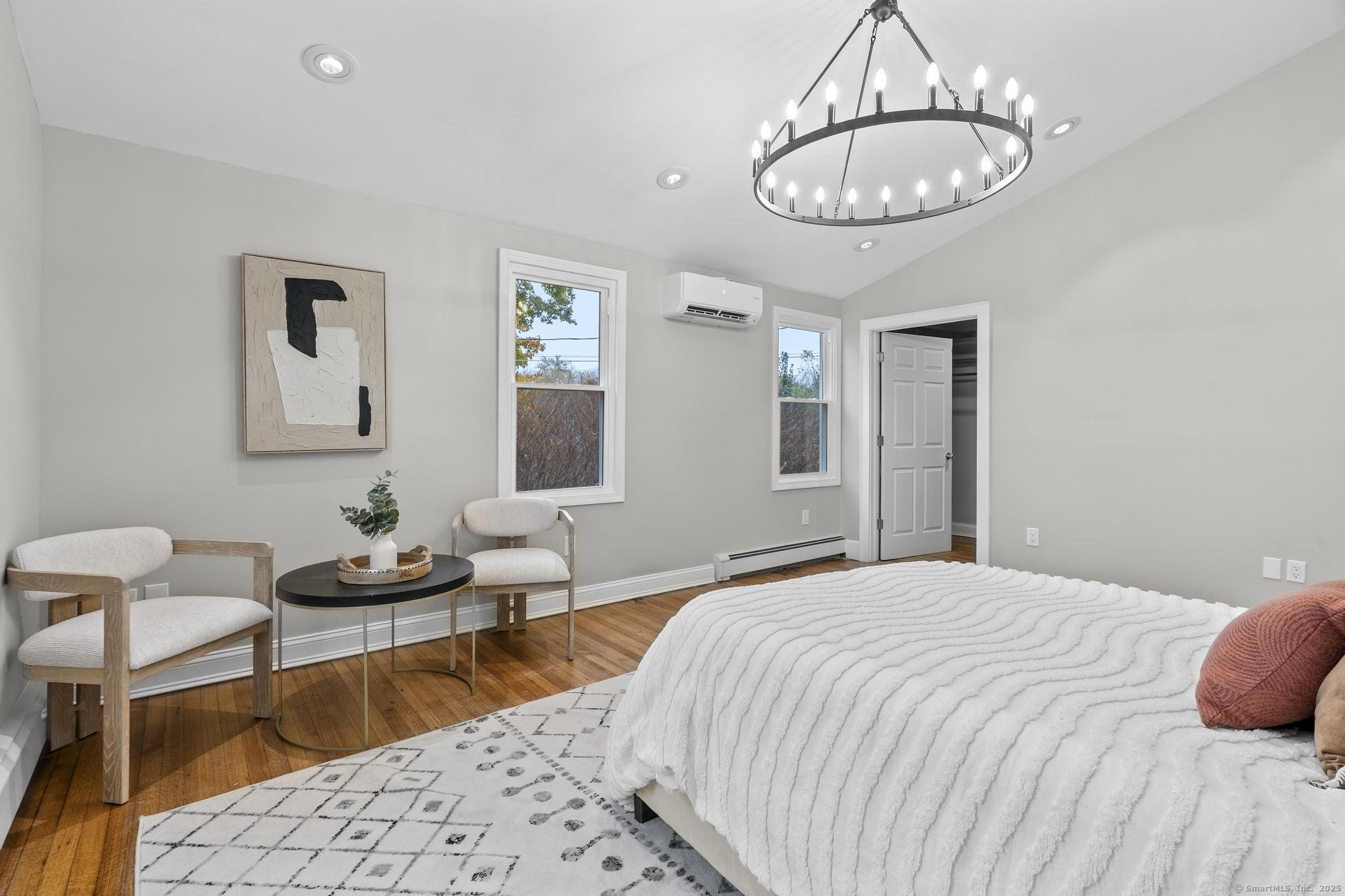 72 Spencer Street Suffield, CT 06078 - Photo 15 of 39 a bedroom with a bed a chandelier and mirror