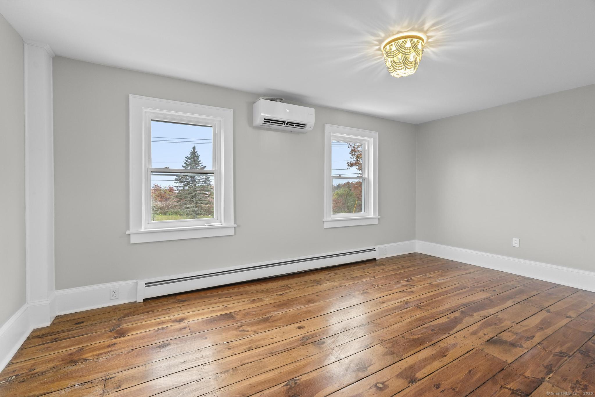72 Spencer Street Suffield, CT 06078 - Photo 19 of 39 a view of an empty room with a window and wooden floor