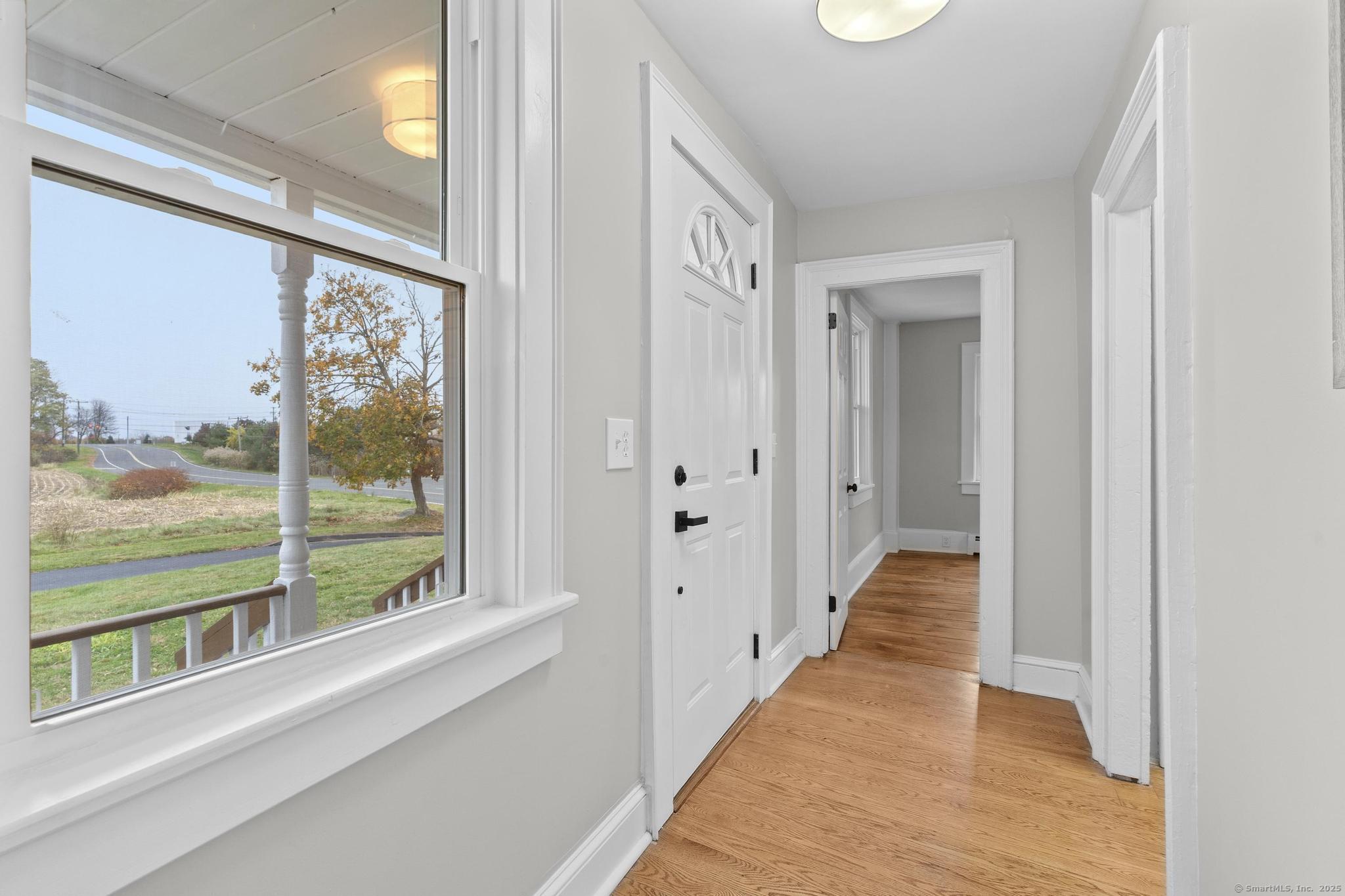 72 Spencer Street Suffield, CT 06078 - Photo 2 of 39 a view of a hallway with wooden floor and windows