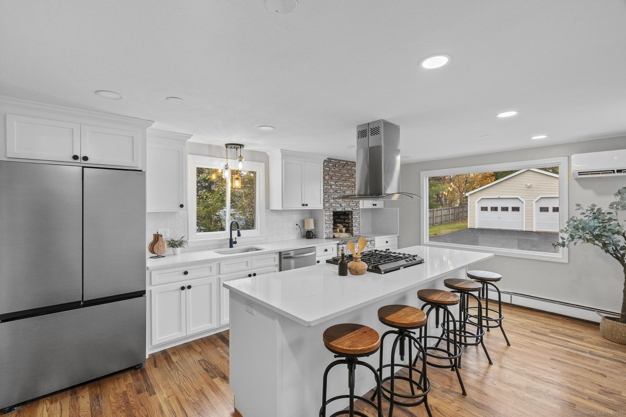 72 Spencer Street Suffield, CT 06078 - Photo 22 of 39 a kitchen with a sink a stove cabinets and wooden floor