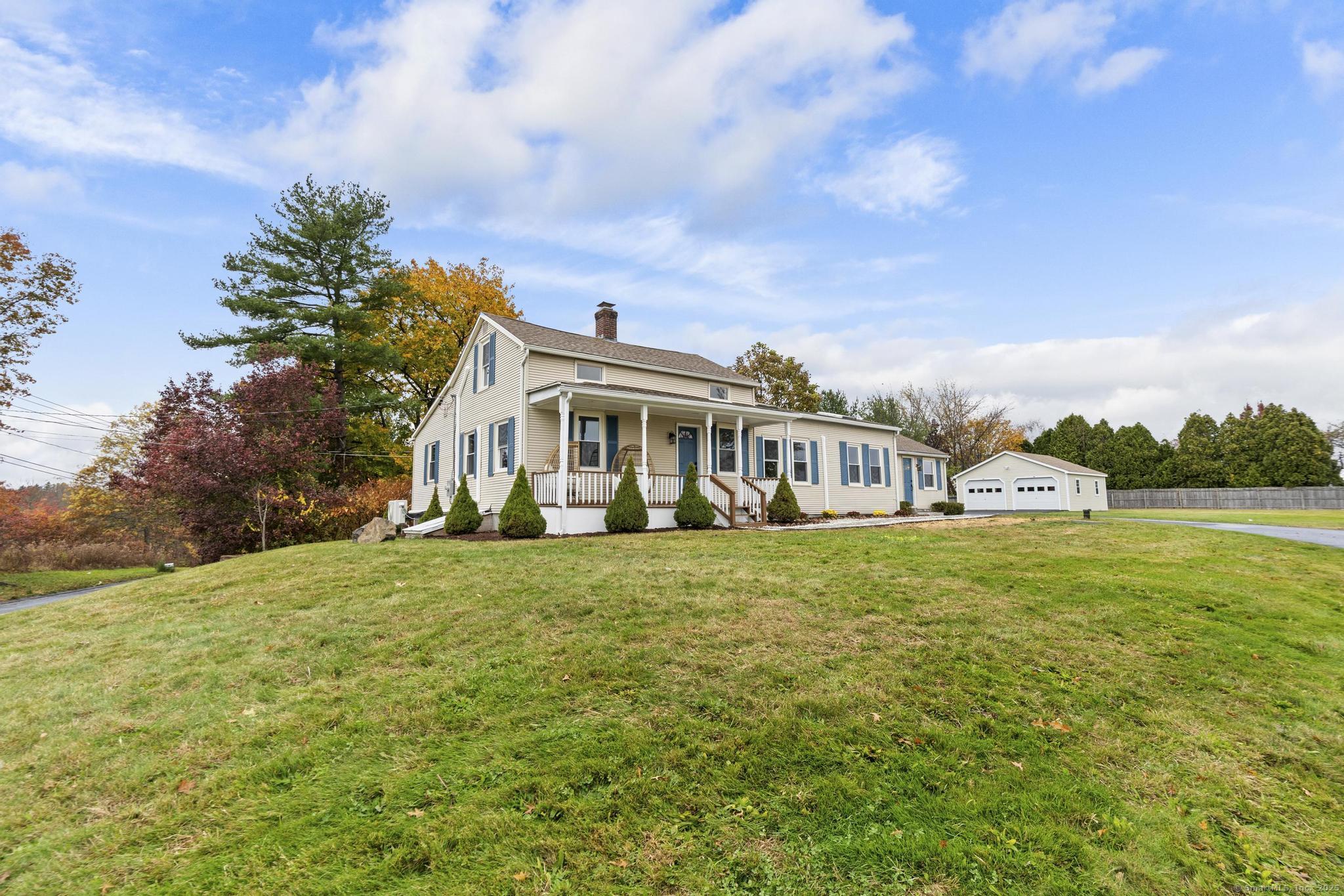 72 Spencer Street Suffield, CT 06078 - Photo 33 of 39 a front view of a house with a garden and yard