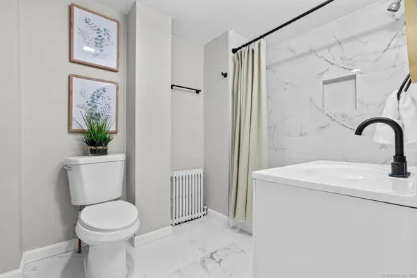 a bathroom with a sink toilet and shower