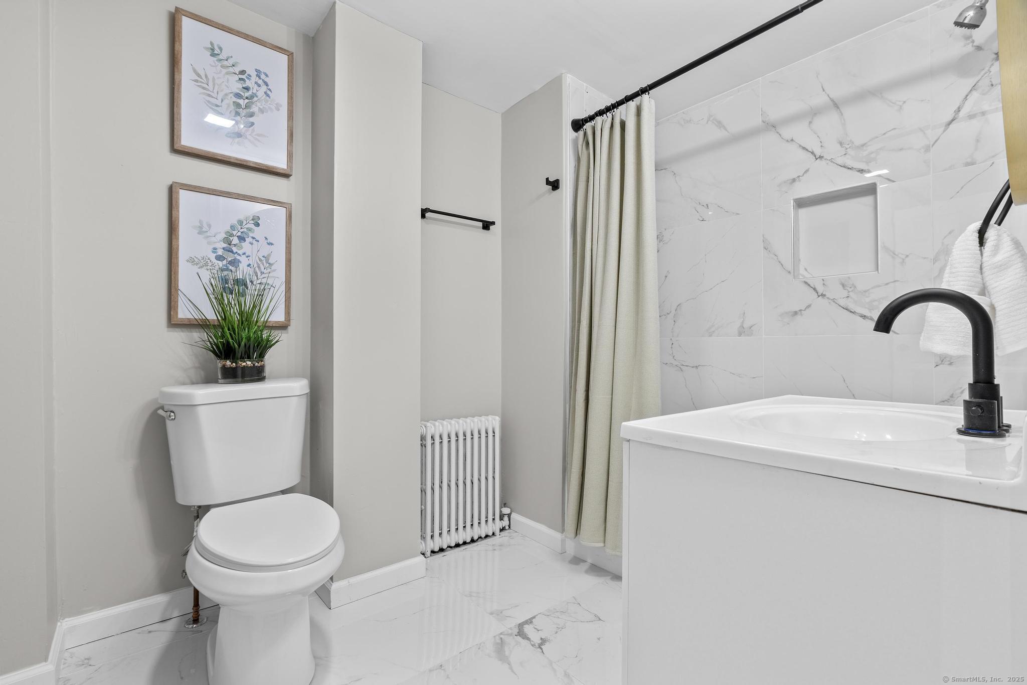 72 Spencer Street Suffield, CT 06078 - Photo 33 of 39 a bathroom with a sink toilet and shower