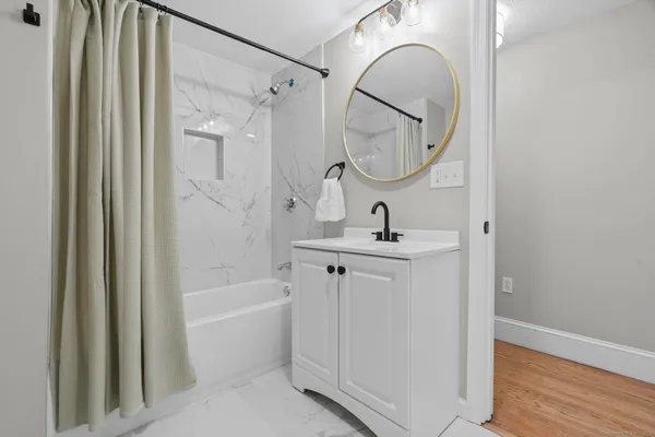 a bathroom with a mirror a sink and a mirror