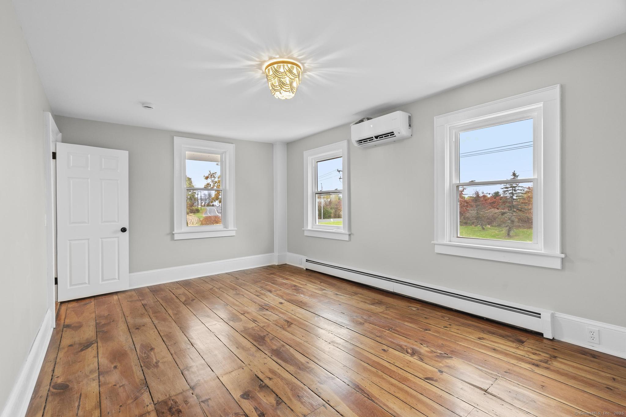 72 Spencer Street Suffield, CT 06078 - Photo 37 of 39 a view of an empty room with wooden floor and a window