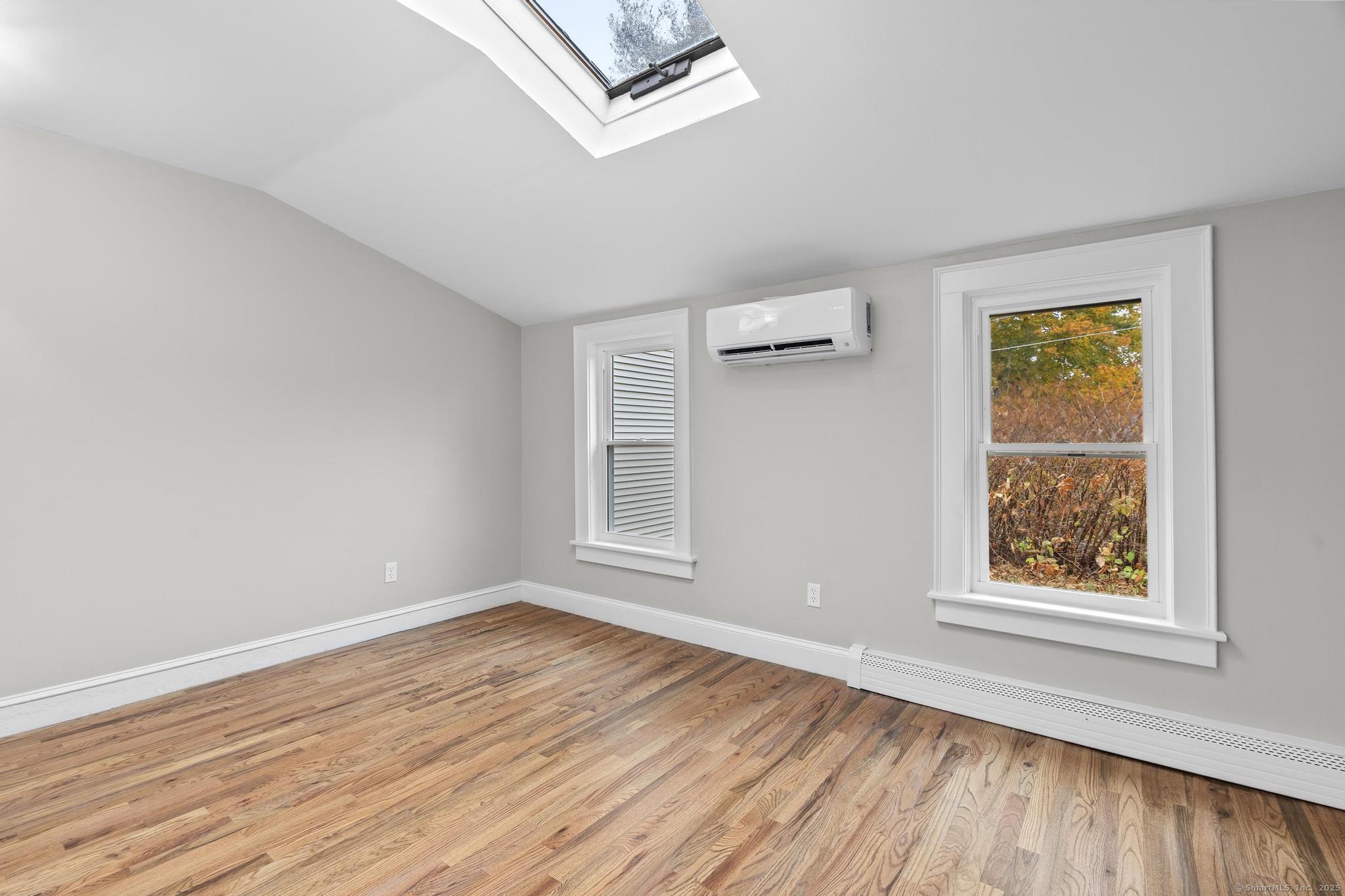 72 Spencer Street Suffield, CT 06078 - Photo 38 of 39 an empty room with wooden floor and windows