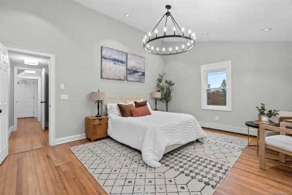 a bedroom with a bed and a chandelier
