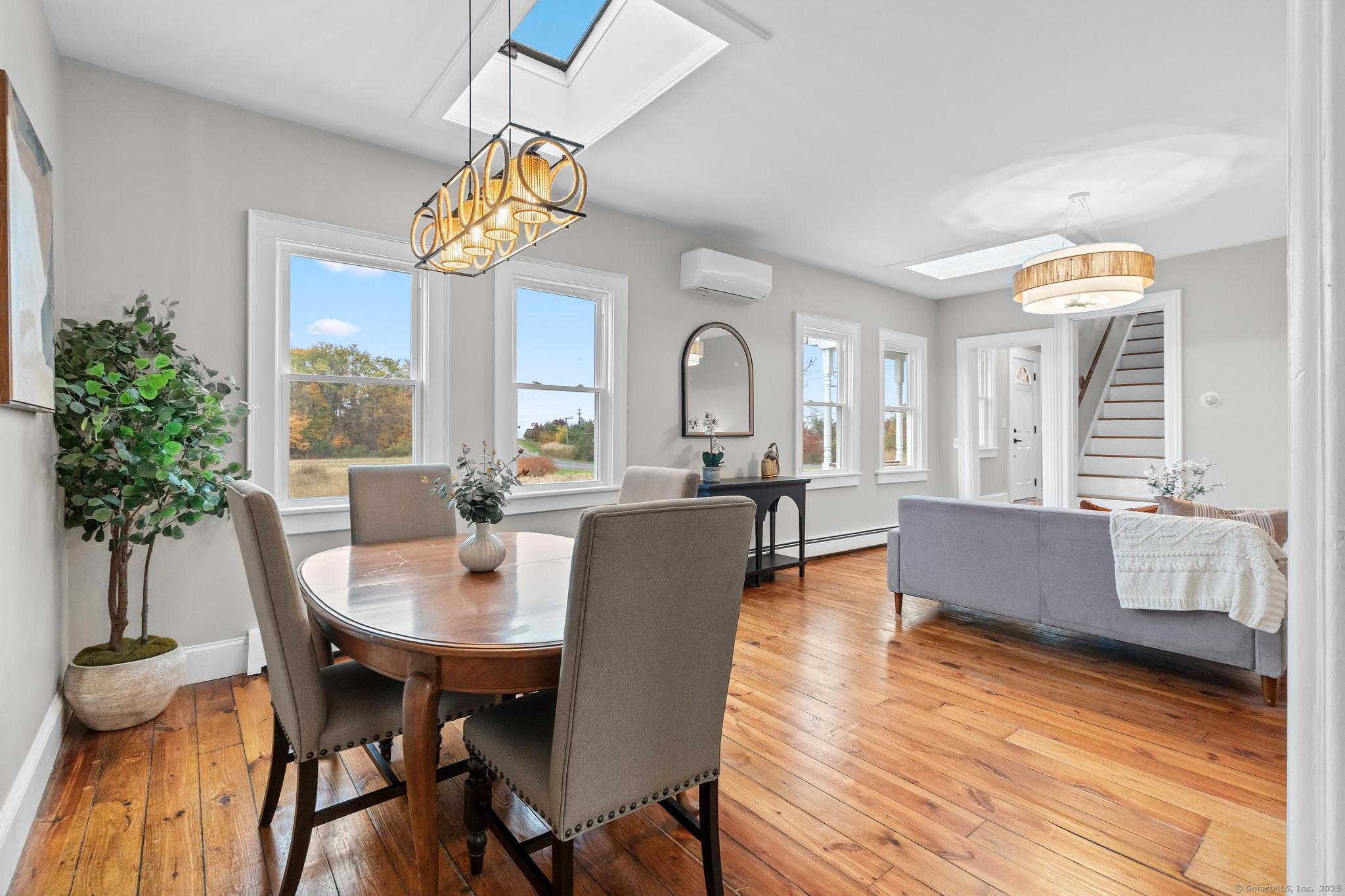 72 Spencer Street Suffield, CT 06078 - Photo 7 of 39 a dining room with furniture potted plants and wooden floor