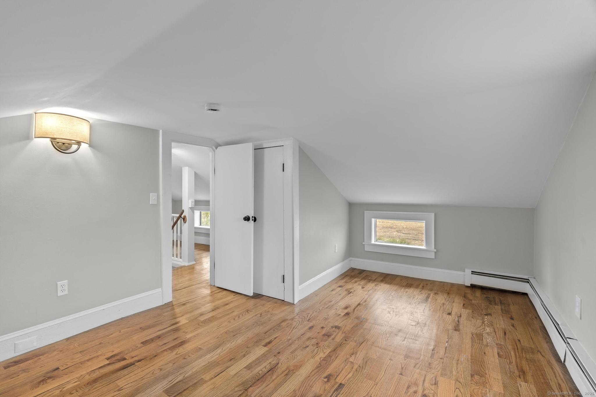 72 Spencer Street Suffield, CT 06078 - Photo 9 of 39 an empty room with wooden floor and windows