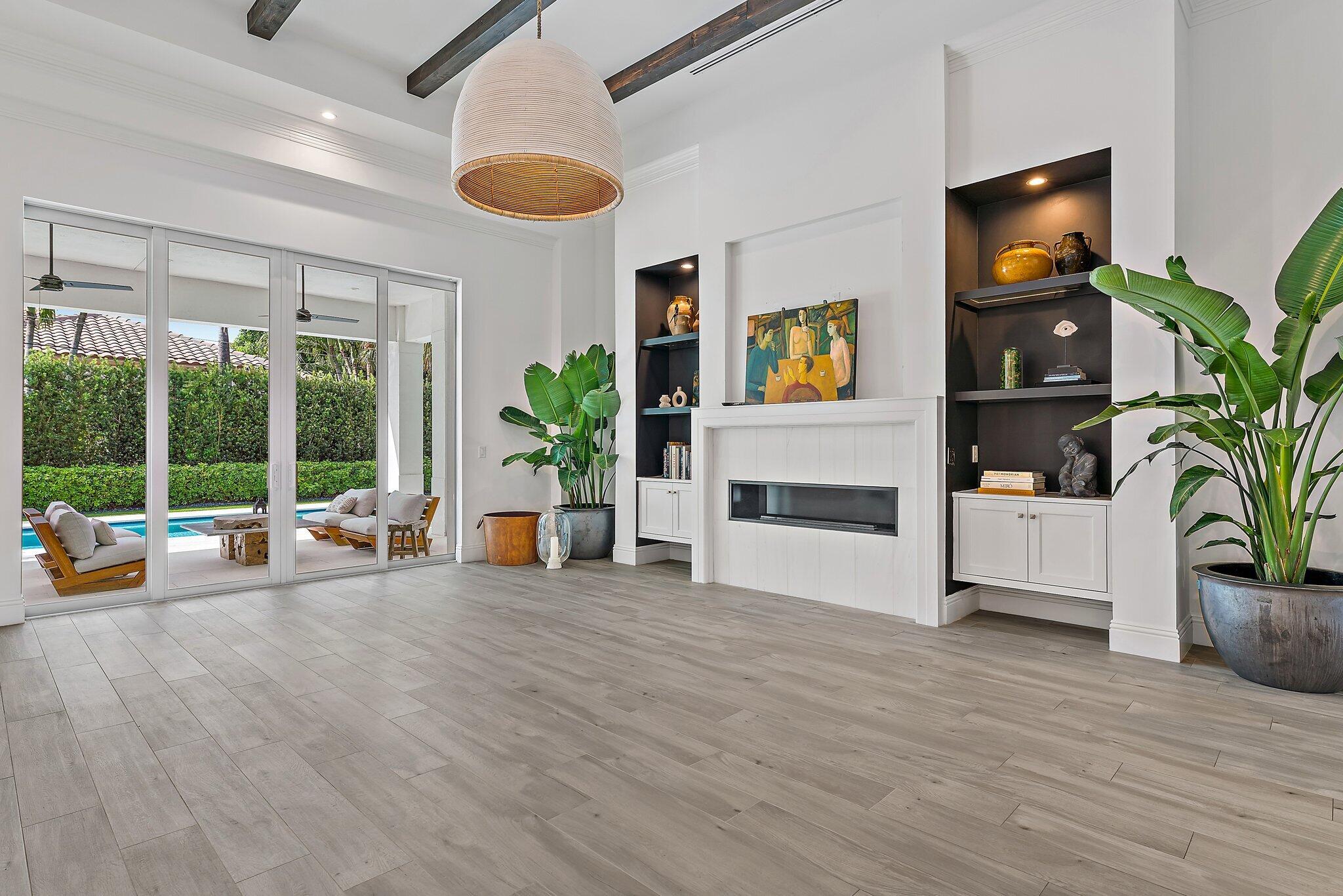 5456 Hibiscus Road Jupiter, FL 33458 - Photo 12 of 48 a view of livingroom with furniture flat screen tv and floor to ceiling window