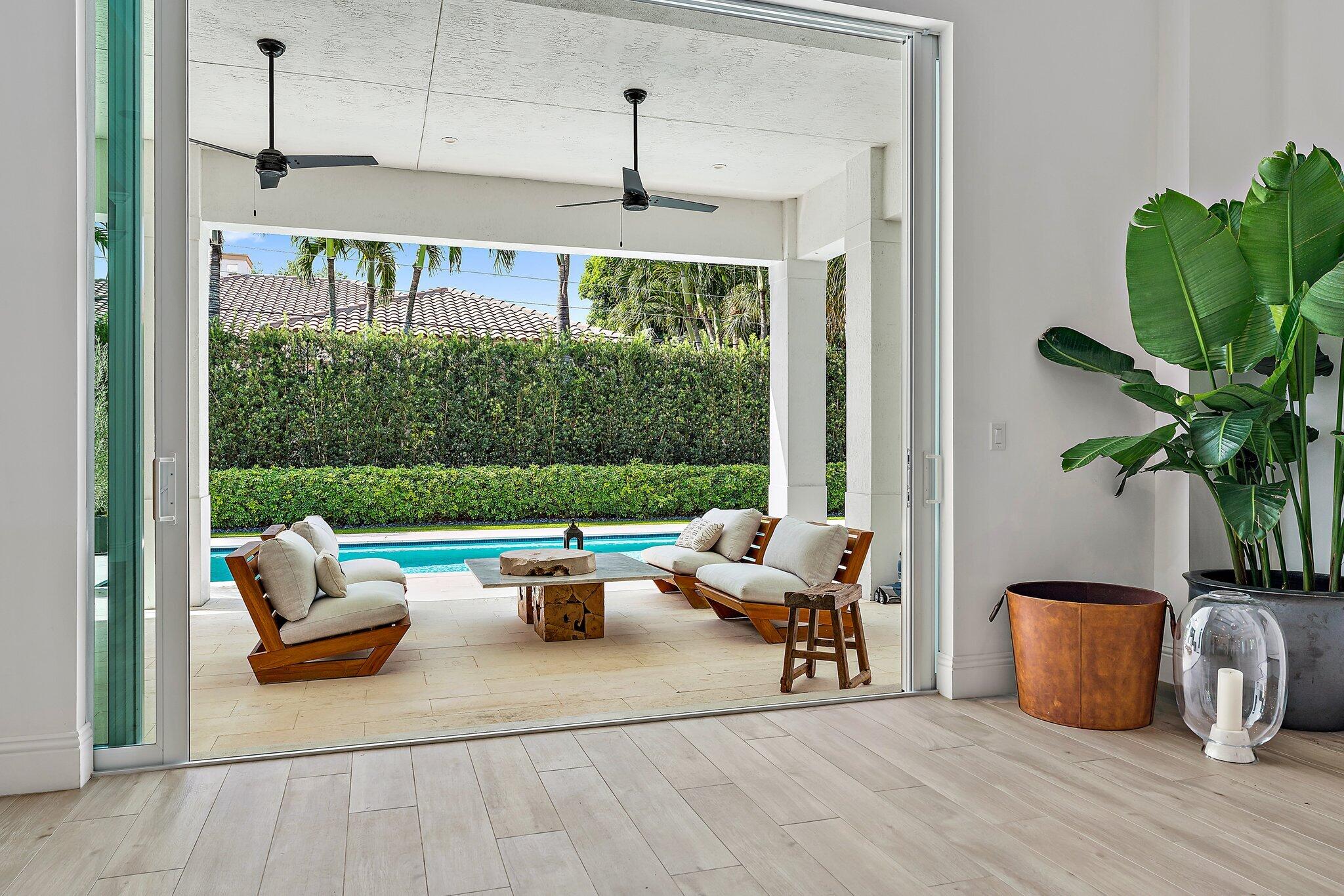 5456 Hibiscus Road Jupiter, FL 33458 - Photo 13 of 48 a living room with patio furniture and a potted plants