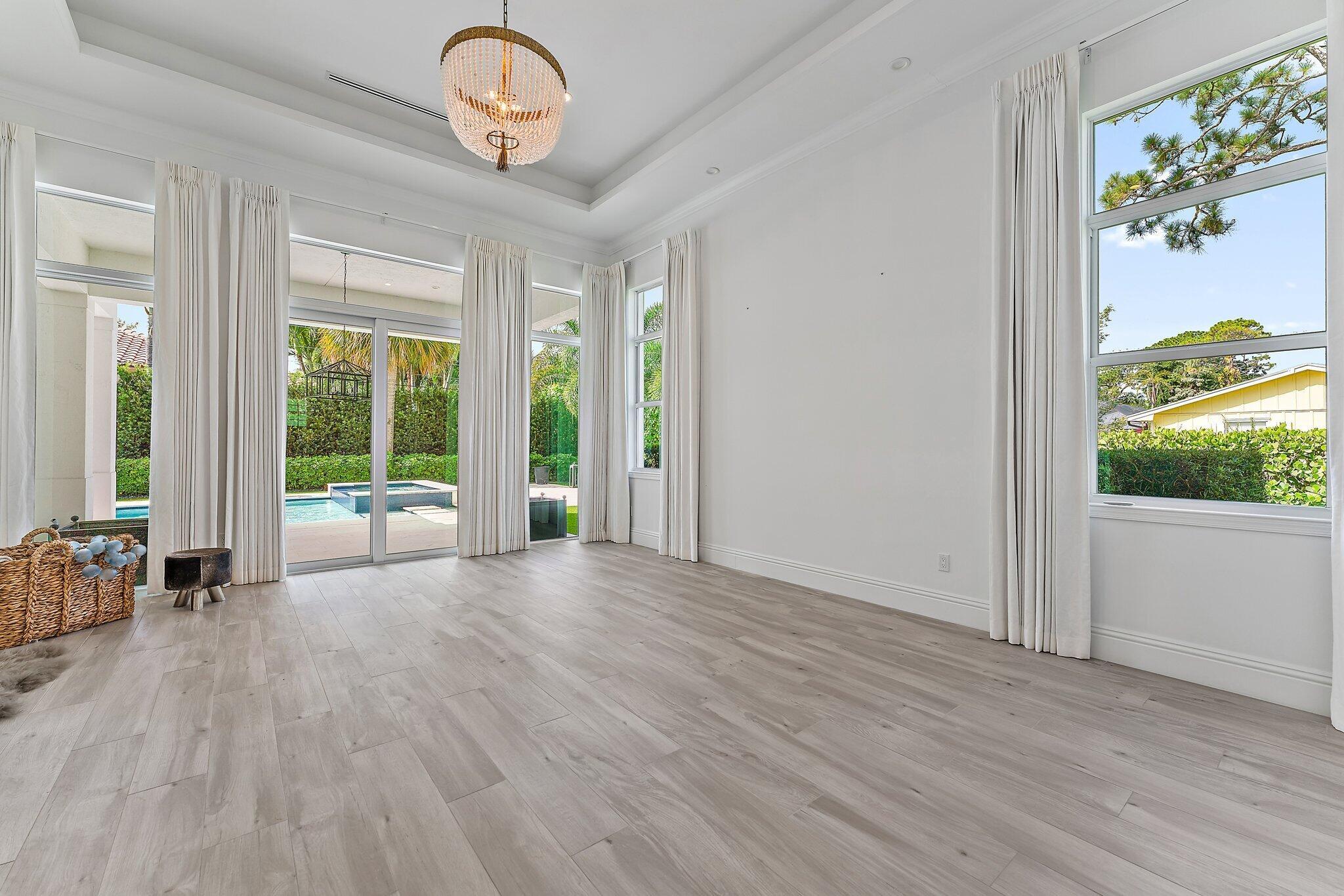 5456 Hibiscus Road Jupiter, FL 33458 - Photo 22 of 48 a view of a livingroom with wooden floor and a large window