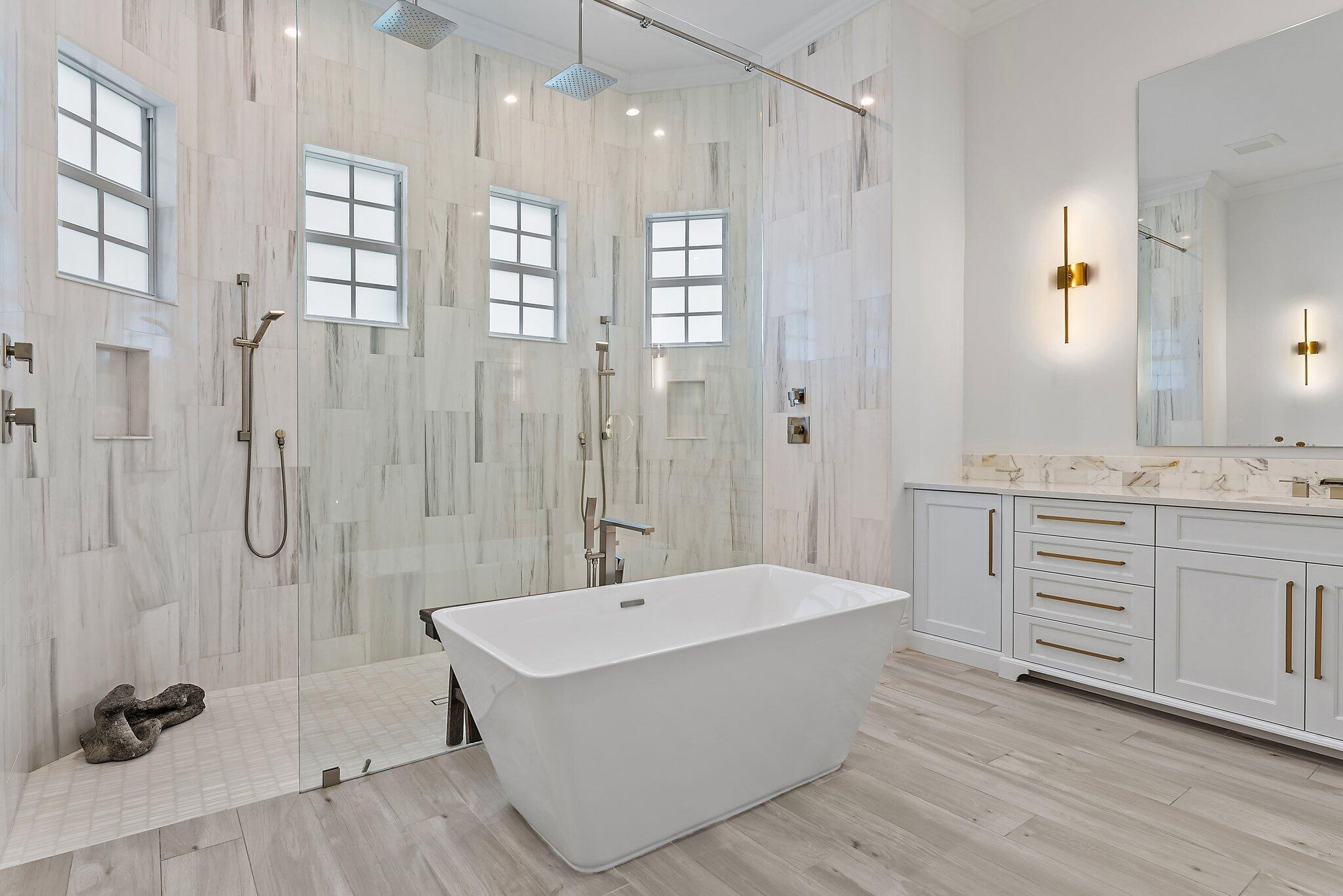 5456 Hibiscus Road Jupiter, FL 33458 - Photo 25 of 48 a bathroom with a tub sink shower and mirror