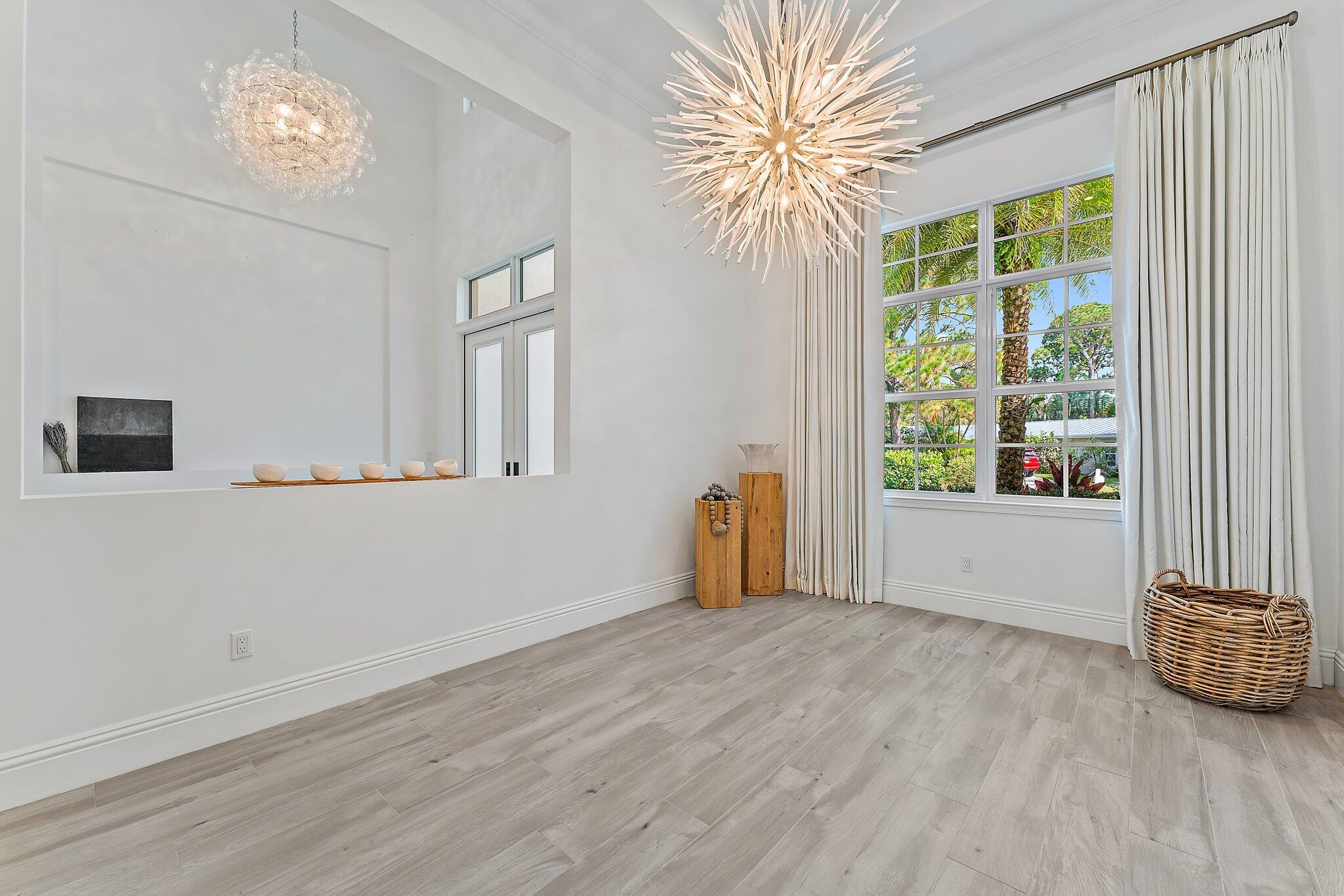 5456 Hibiscus Road Jupiter, FL 33458 - Photo 33 of 48 a view of an empty room with a window and wooden floor