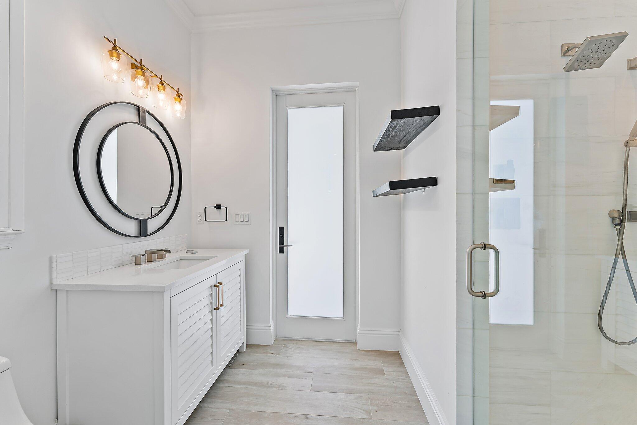 5456 Hibiscus Road Jupiter, FL 33458 - Photo 34 of 48 a bathroom with a sink a toilet and a mirror