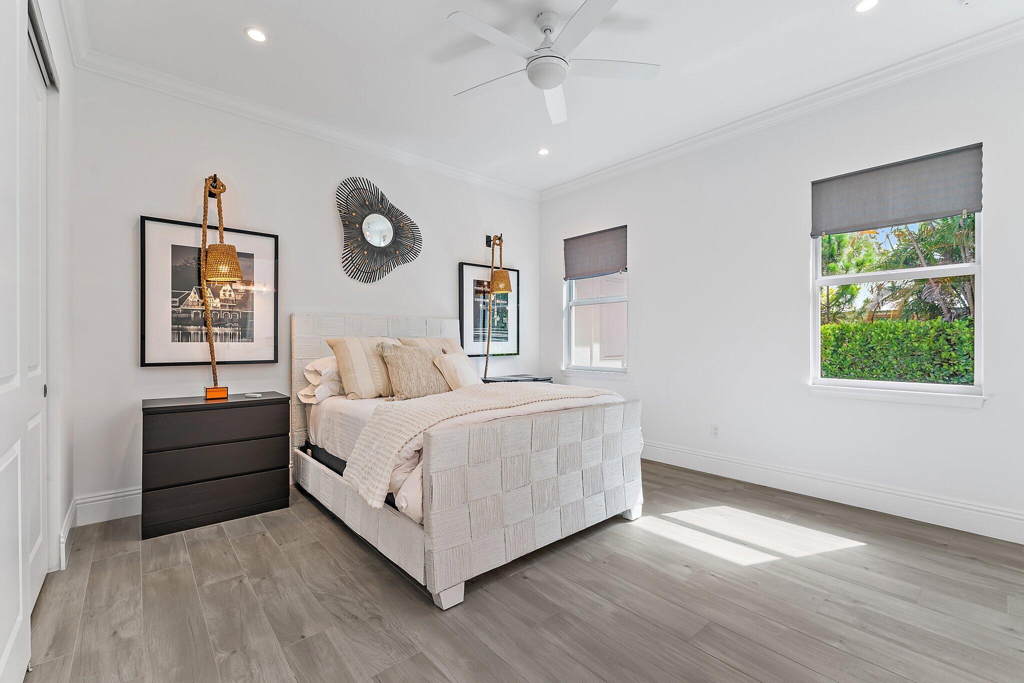 5456 Hibiscus Road Jupiter, FL 33458 - Photo 37 of 48 a spacious bedroom with a bed and a window