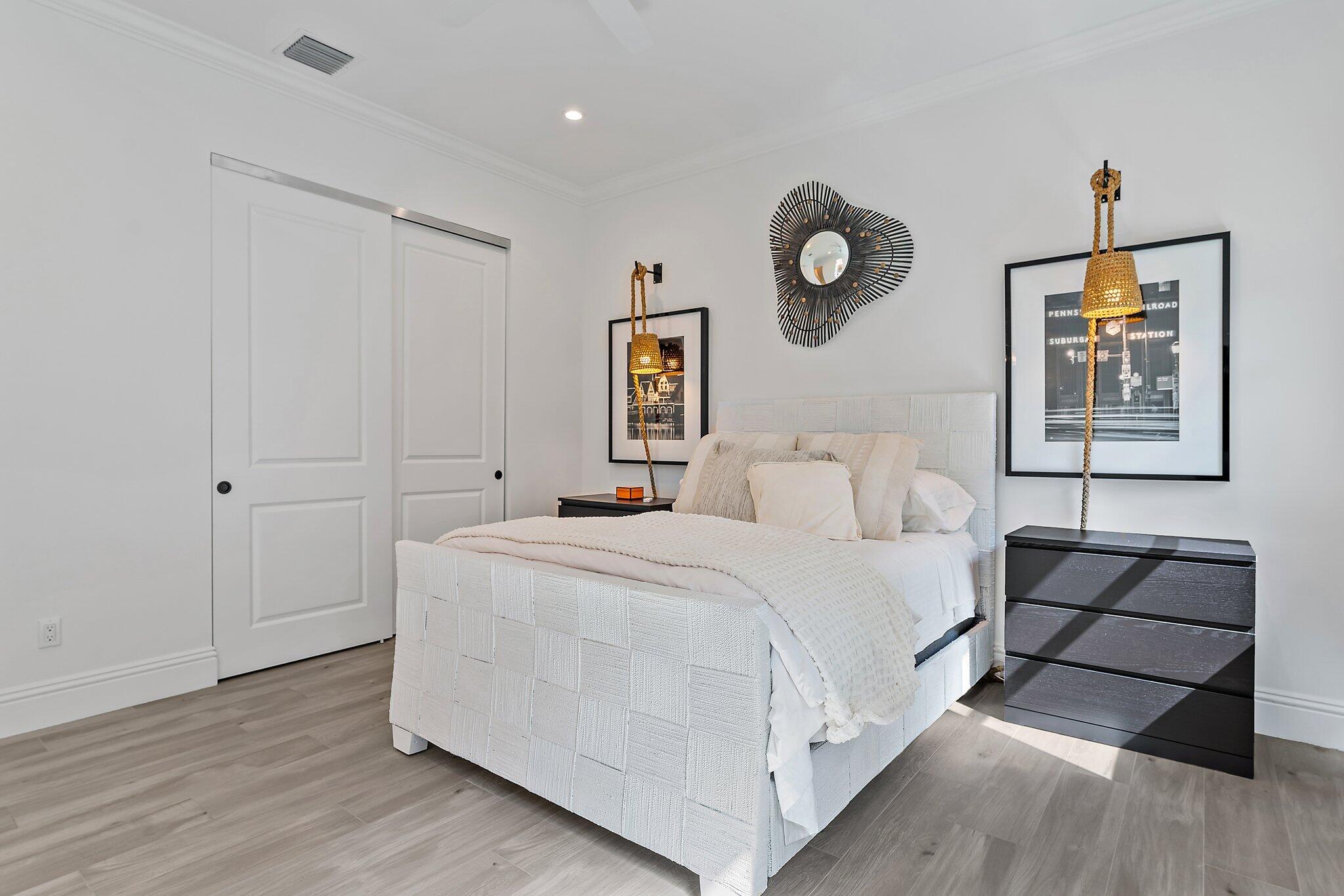 5456 Hibiscus Road Jupiter, FL 33458 - Photo 38 of 48 a bed room with a bed and painting on the wall