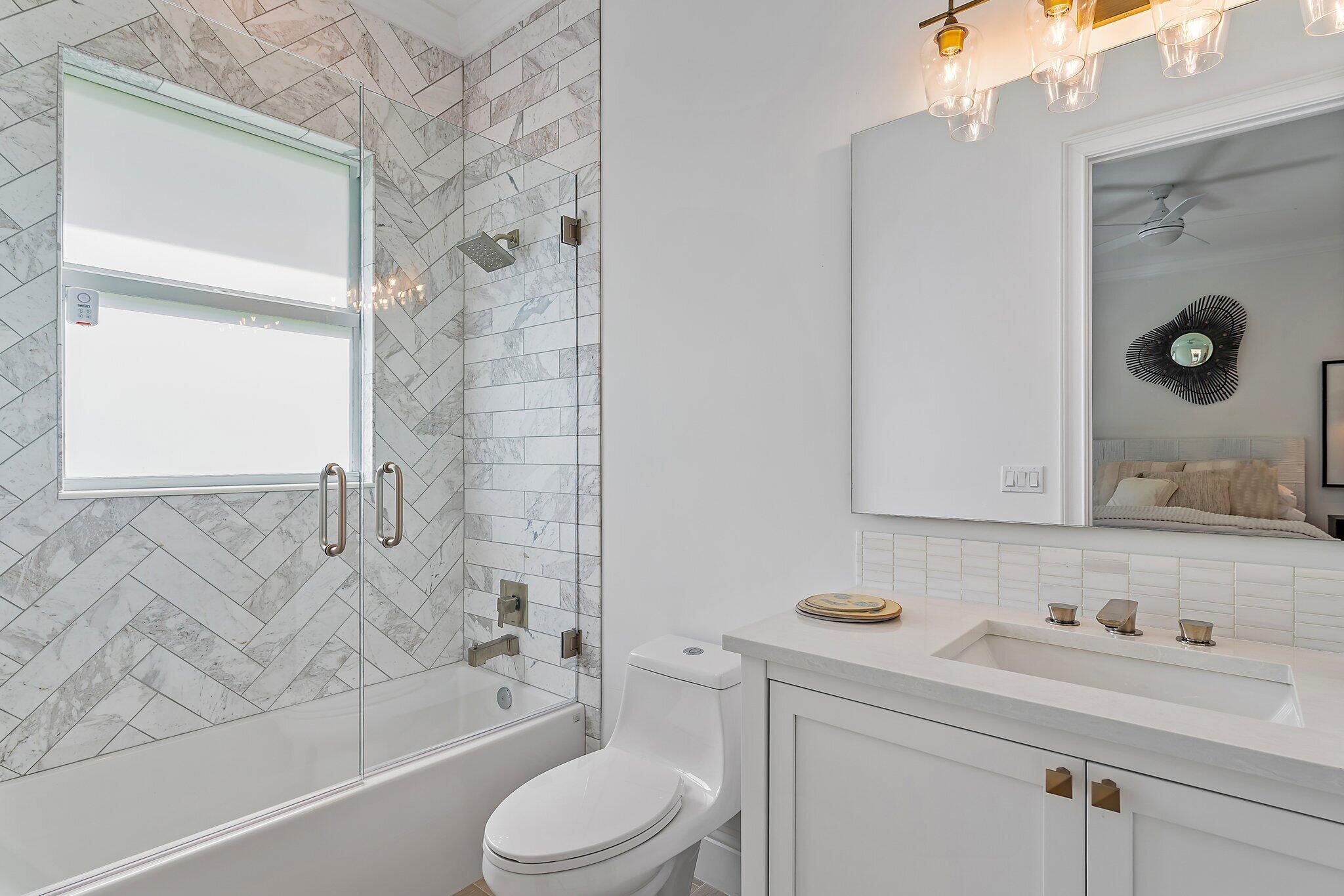 5456 Hibiscus Road Jupiter, FL 33458 - Photo 39 of 48 a bathroom with a granite countertop sink a toilet and shower