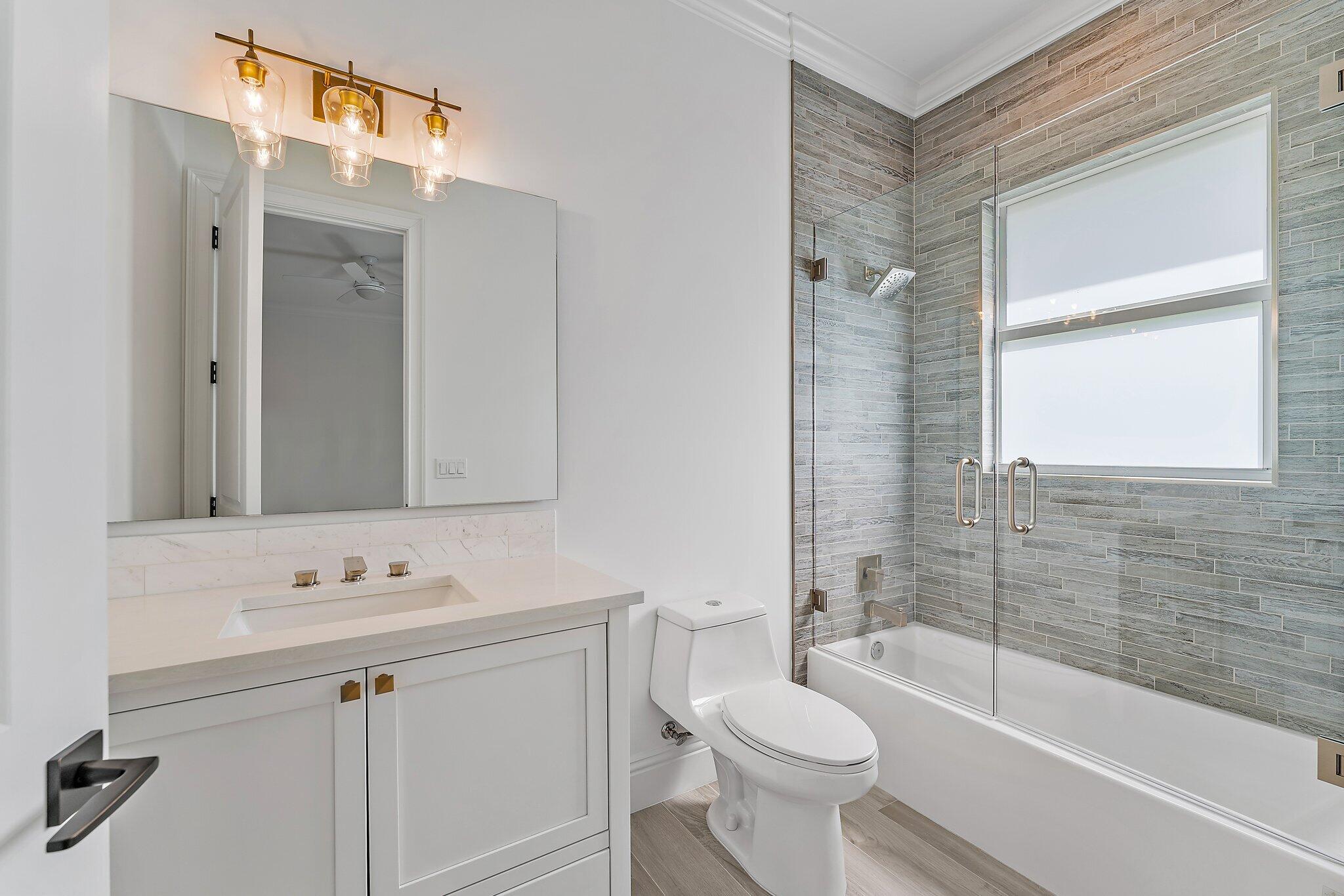 5456 Hibiscus Road Jupiter, FL 33458 - Photo 40 of 48 a bathroom with a sink a toilet and shower