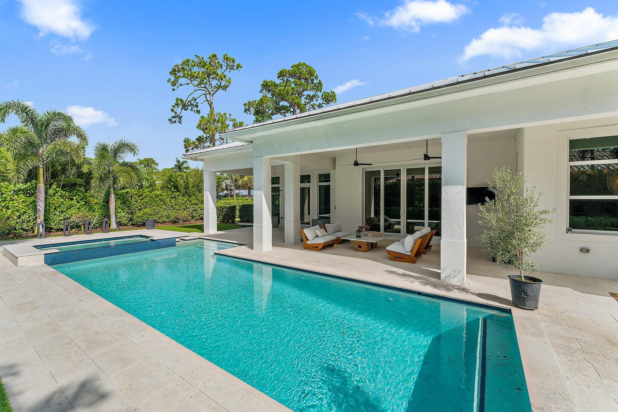 5456 Hibiscus Road Jupiter, FL 33458 - Photo 44 of 48 a view of a house with swimming pool and sitting area