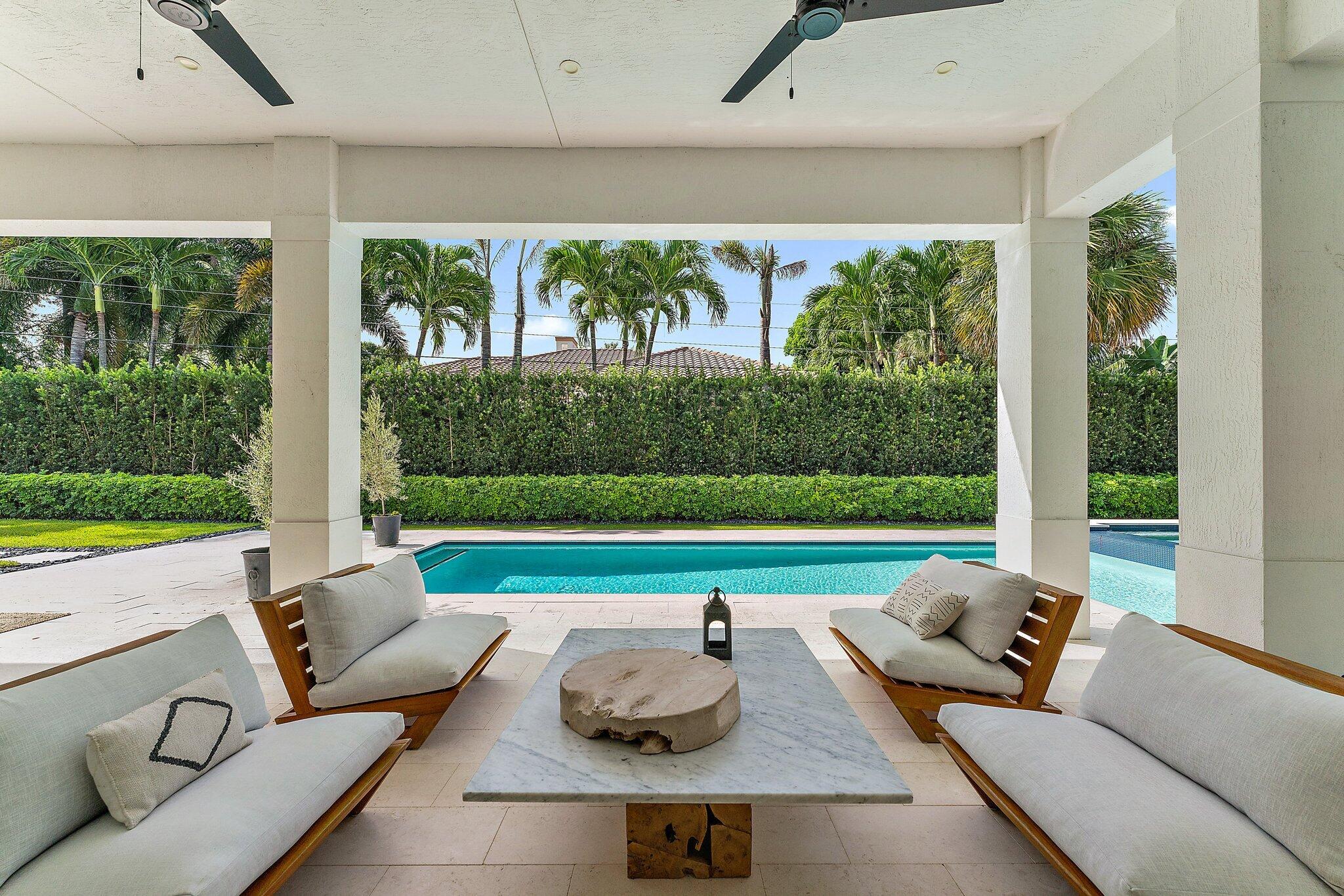 5456 Hibiscus Road Jupiter, FL 33458 - Photo 8 of 48 a living room with patio furniture and a garden