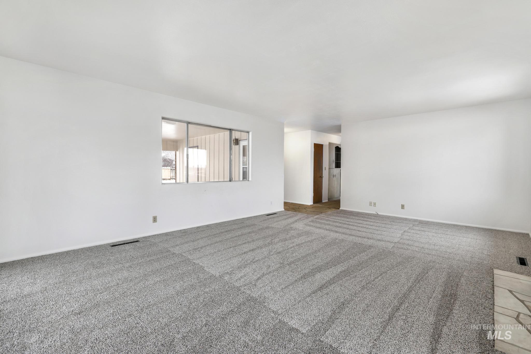 409 Clear Lakes Road Buhl, ID 83316 - Photo 6 of 43 Carpeted spare room with baseboards