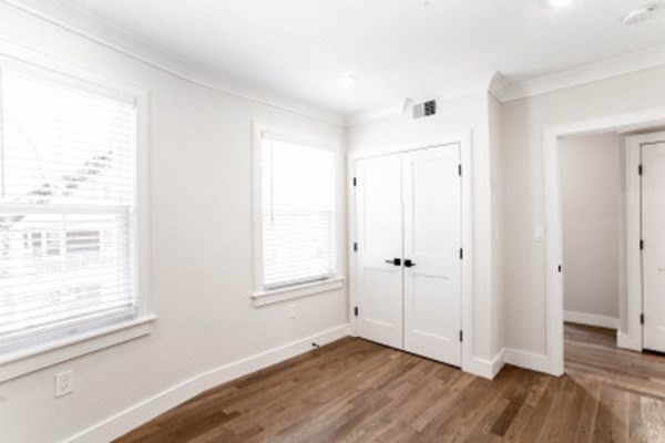 14 Atkins Street, Unit 1 Boston, MA 02135 - Photo 7 of 11 a view of an empty room with wooden floor and a window