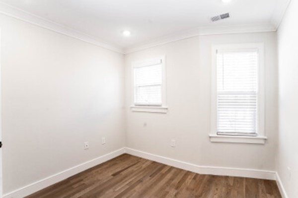 14 Atkins Street, Unit 1 Boston, MA 02135 - Photo 8 of 11 an empty room with wooden floor and windows