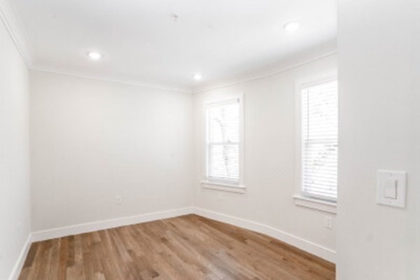 14 Atkins Street, Unit 1 Boston, MA 02135 - Photo 9 of 11 an empty room with wooden floor and windows
