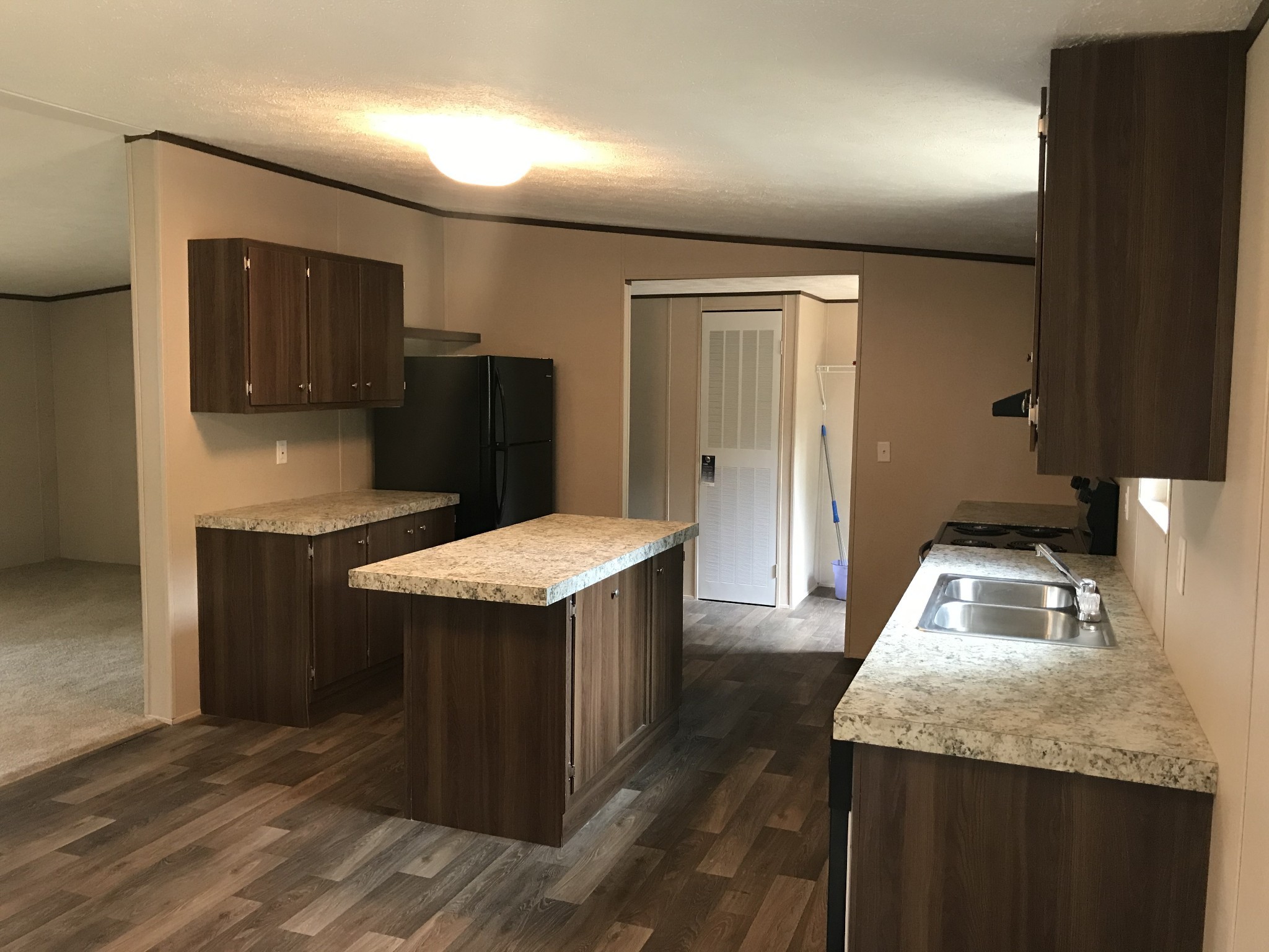 139 Harbin Road Fayetteville, TN 37334 - Photo 3 of 13 a kitchen with stainless steel appliances granite countertop a sink a refrigerator and a stove