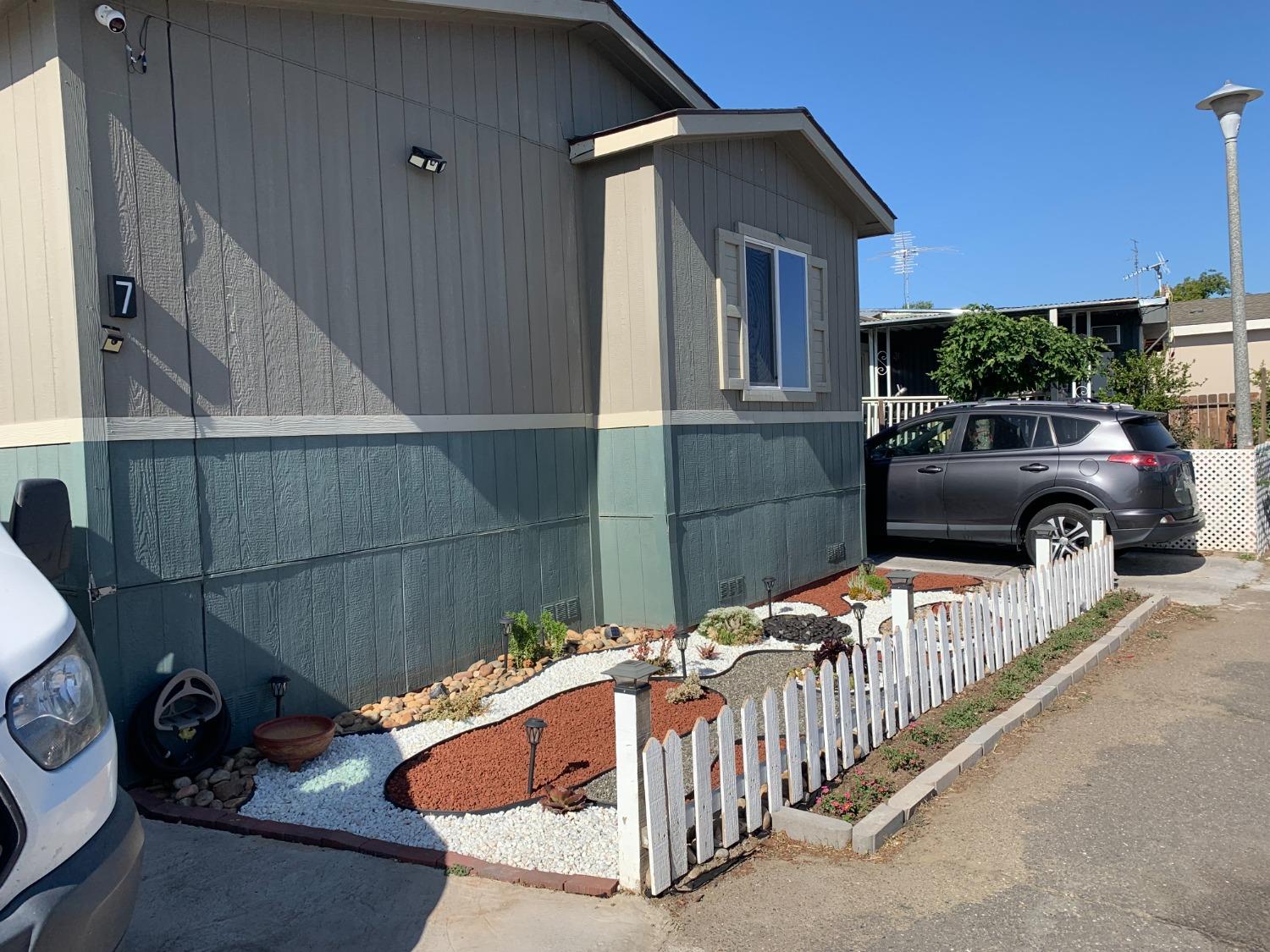 1624 South State Route 99 E Frontage Road, Unit 7 Manteca, CA 95336 - Photo 2 of 12 a view of a house with a cars park side of a road